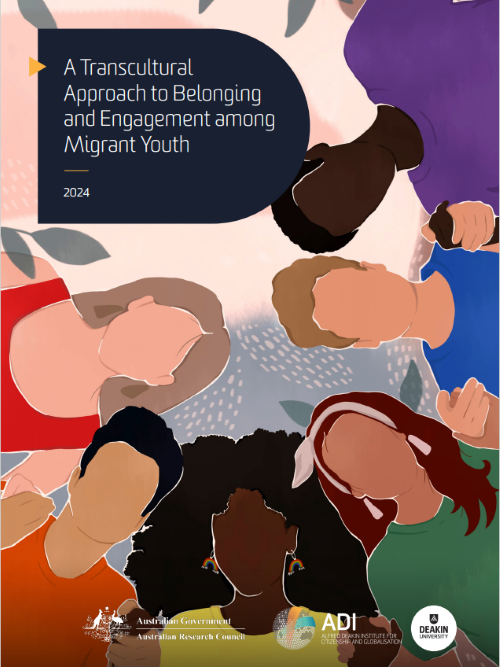 A woman wearing a peach coloured hijab and a lighter pink top, sitting on the sand at the beach in bright daylight. We see her from the back, facing the waves.