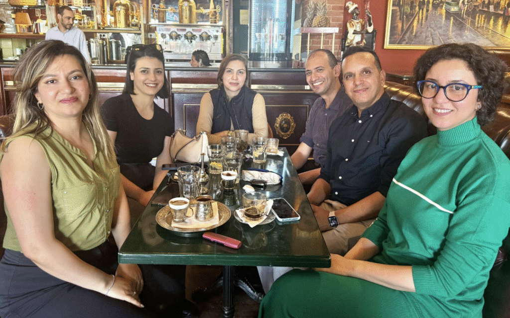 A group of people sitting in a booth at a restaurant around a table in Tunisia